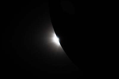 Sunlight peeking around the Moon limb